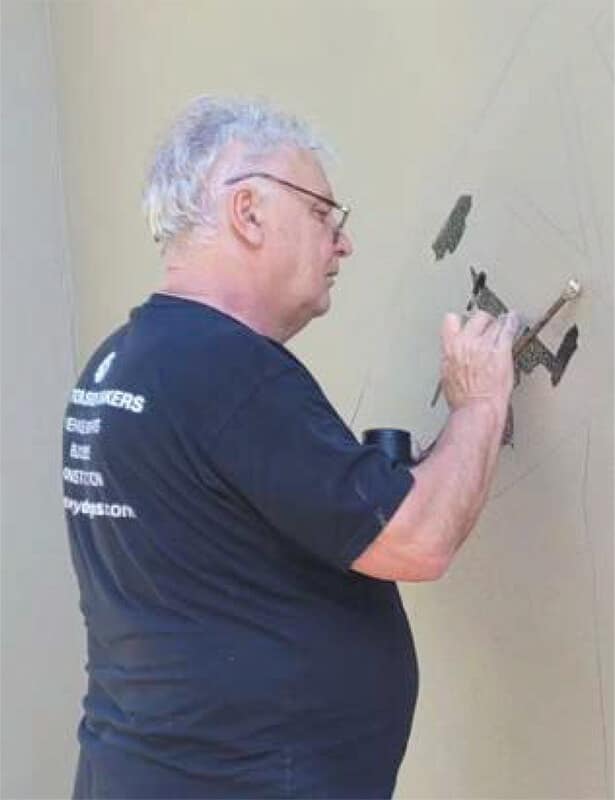 Craftsman applying vinyl signage